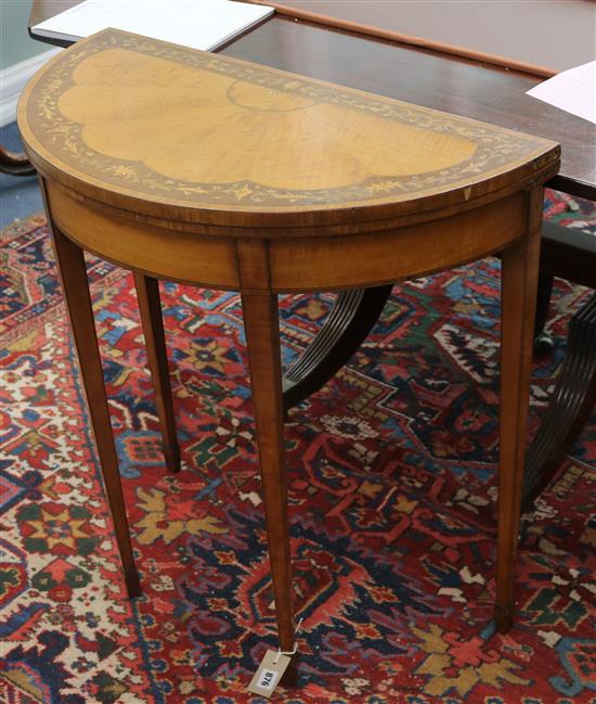 An Edwardian Sheraton revival inlaid satinwood demi-lune card table W.72cm
